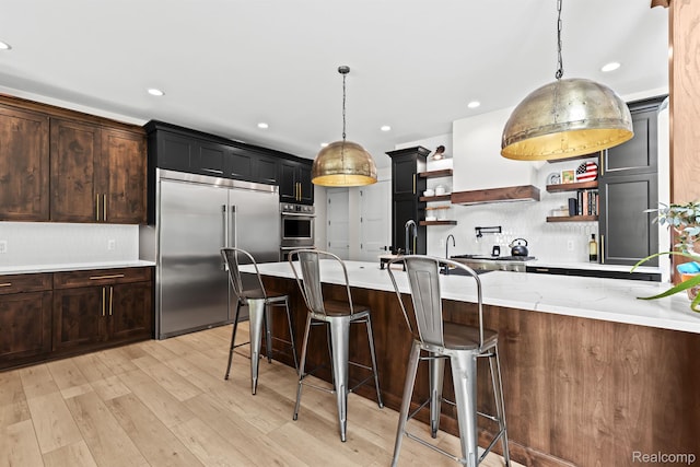 4286 Center Rd, Linden, MI 48451 - kitchen featuring appliances with stainless steel finishes, open shelves, custom range hood, hanging light fixtures, and recessed lighting