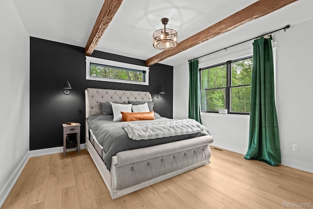 4286 Center Rd, Linden, MI 48451 - bedroom with beam ceiling, multiple windows, light wood finished floors, and a chandelier
