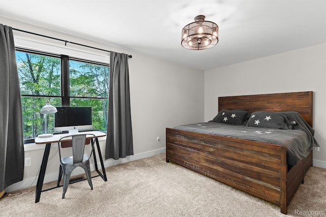 4286 Center Rd, Linden, MI 48451 - carpeted bedroom featuring baseboards and a chandelier