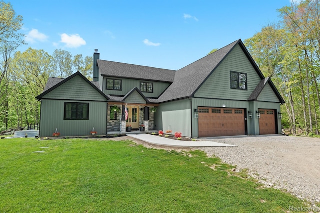 4286 Center Rd, Linden, MI 48451 - view of front facade featuring a chimney, gravel driveway, a porch, a front yard, and an attached garage