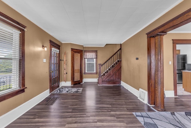 843 Center St, Jackson, MI 49202 - foyer featuring wood finished floors, crown molding, stairway, and decorative columns