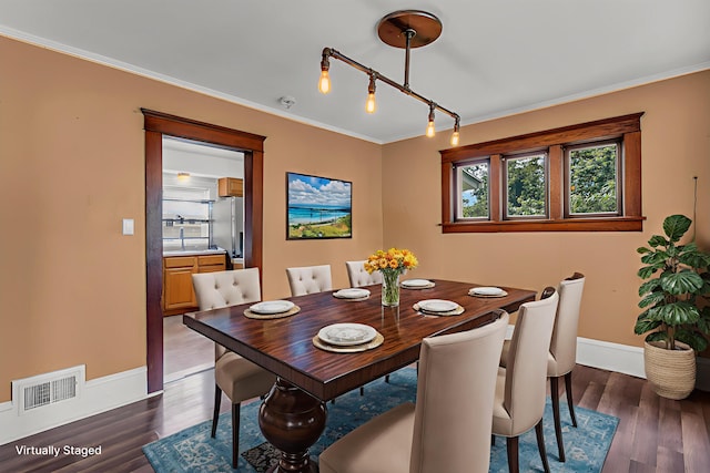 843 Center St, Jackson, MI 49202 - dining space with healthy amount of natural light, dark wood-style flooring, ornamental molding, and track lighting