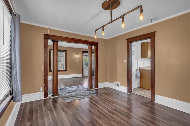 843 Center St, Jackson, MI 49202 - empty room with decorative columns, wood finished floors, crown molding, and fire sprinkler in ceiling
