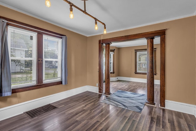 843 Center St, Jackson, MI 49202 - unfurnished room featuring ornate columns, ornamental molding, and wood finished floors