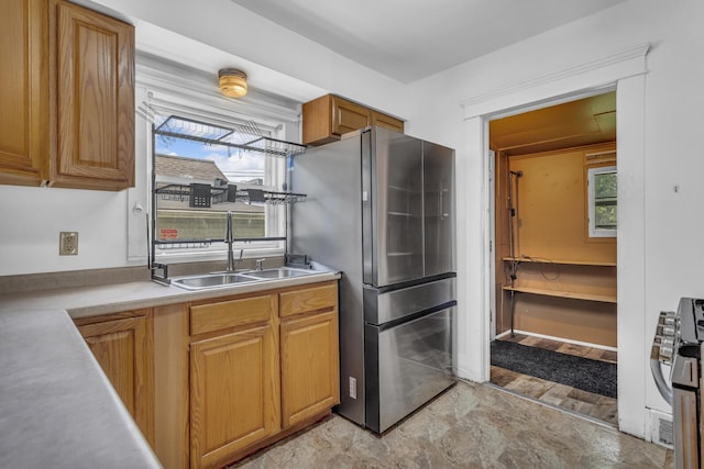 843 Center St, Jackson, MI 49202 - kitchen featuring stainless steel appliances, light countertops, and brown cabinets