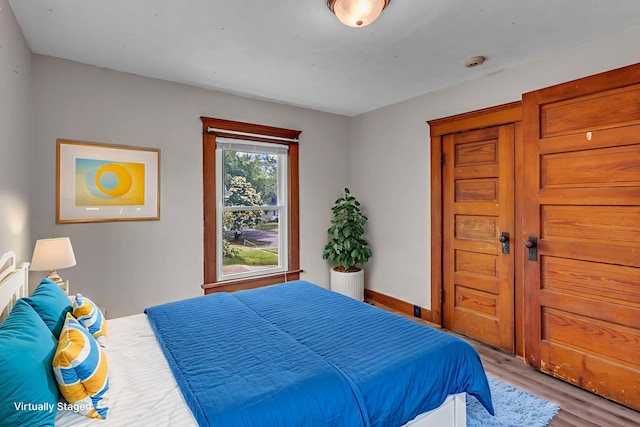 843 Center St, Jackson, MI 49202 - bedroom featuring wood finished floors and baseboards