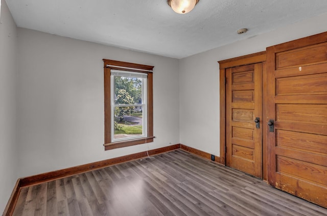 843 Center St, Jackson, MI 49202 - empty room with wood finished floors and a smoke detector