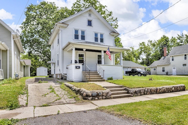 843 Center St, Jackson, MI 49202 - american foursquare style home with a porch, a storage unit, and a front yard