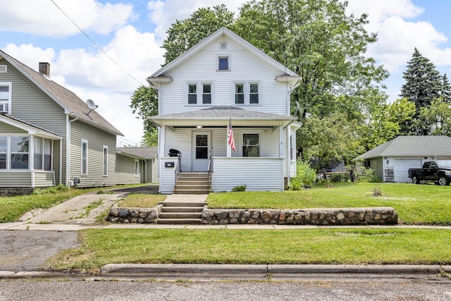 843 Center St, Jackson, MI 49202 - american foursquare style home featuring covered porch, a front yard, and driveway