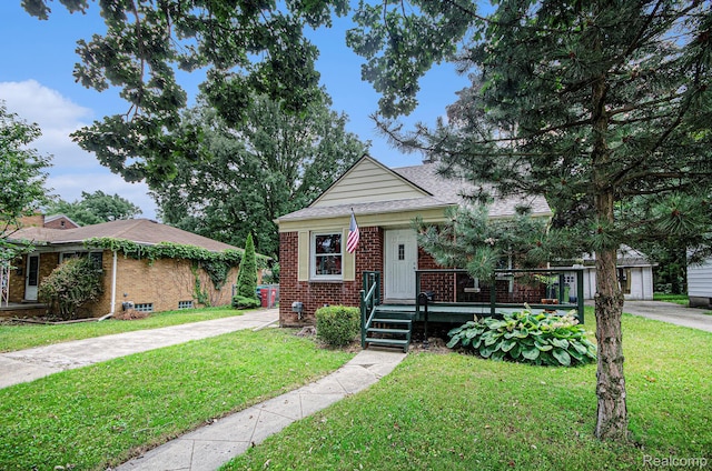 15042 Charles R Ave, Eastpointe, MI 48021 - bungalow-style house with a front lawn, brick siding, and covered porch
