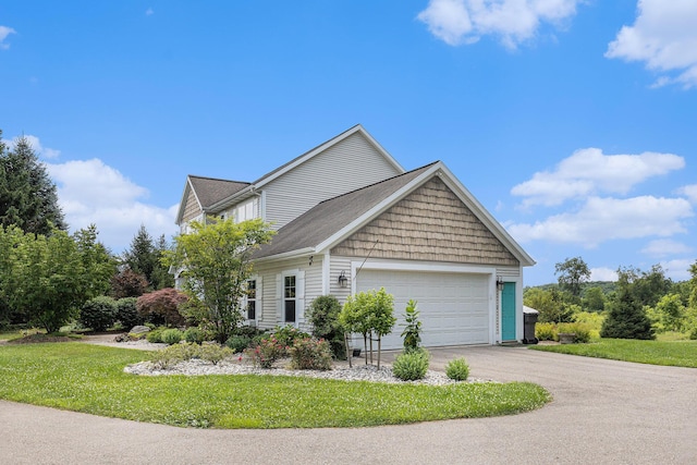 8608 52nd St SE, Ada, MI 49301 - view of front of house featuring driveway, an attached garage, and a front lawn