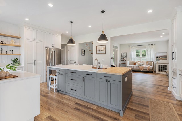 8608 52nd St SE, Ada, MI 49301 - kitchen featuring gray cabinets, white cabinetry, a center island, wood finished floors, and recessed lighting