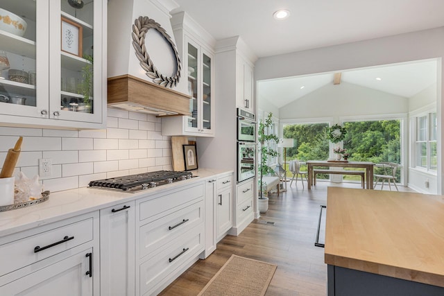 8608 52nd St SE, Ada, MI 49301 - kitchen featuring stainless steel appliances, healthy amount of natural light, butcher block counters, decorative backsplash, and recessed lighting