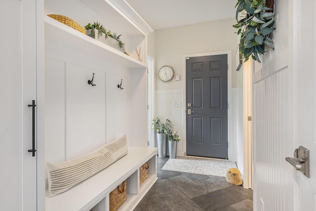 8608 52nd St SE, Ada, MI 49301 - mudroom featuring dark stone finish floors and wainscoting