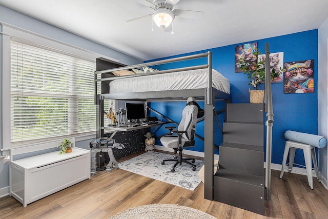 8608 52nd St SE, Ada, MI 49301 - bedroom with wood finished floors, a desk, and ceiling fan