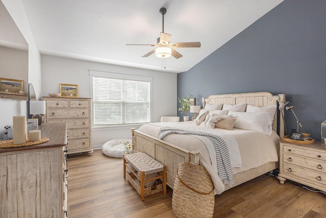 8608 52nd St SE, Ada, MI 49301 - bedroom featuring wood finished floors, vaulted ceiling, and ceiling fan