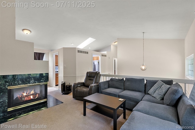 2601 Eardman Ct, Westland, MI 48186 - living room featuring carpet, lofted ceiling, a fireplace, and a skylight
