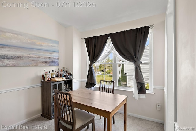 2601 Eardman Ct, Westland, MI 48186 - dining area featuring light colored carpet and a bar