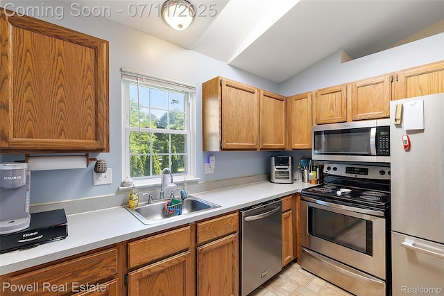 2601 Eardman Ct, Westland, MI 48186 - kitchen featuring stainless steel appliances, light countertops, vaulted ceiling, and brown cabinetry