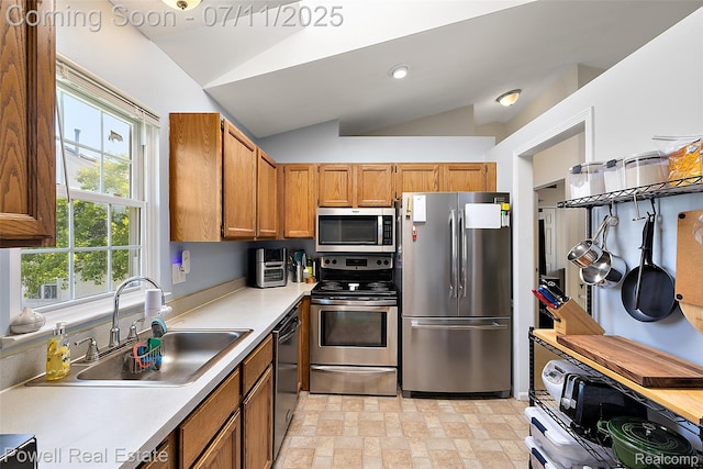2601 Eardman Ct, Westland, MI 48186 - kitchen featuring stainless steel appliances, vaulted ceiling, brown cabinets, and light countertops