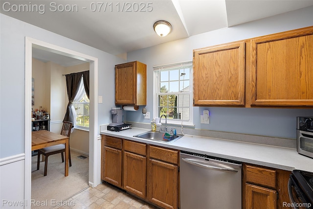2601 Eardman Ct, Westland, MI 48186 - kitchen with stainless steel dishwasher, light countertops, healthy amount of natural light, and black range oven