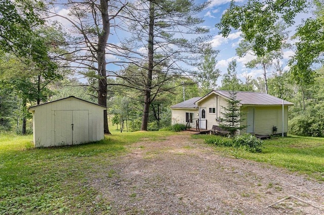 1873 Sanderson Rd, Prescott, MI 48756 - view of green lawn featuring a storage shed and dirt driveway