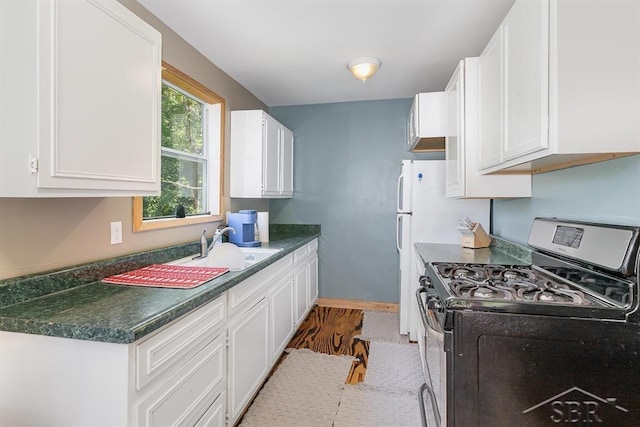 1873 Sanderson Rd, Prescott, MI 48756 - kitchen featuring gas stove, white cabinetry, dark countertops, and wood finished floors