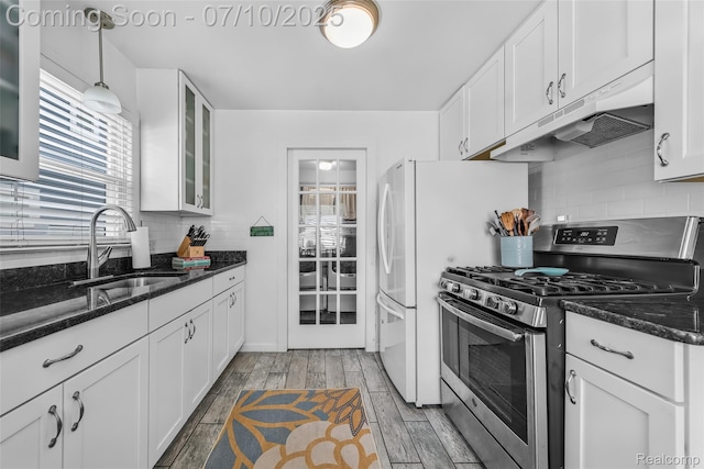 2216 Barrett Ave, Royal Oak, MI 48067 - kitchen with gas range, under cabinet range hood, white cabinets, glass insert cabinets, and tasteful backsplash