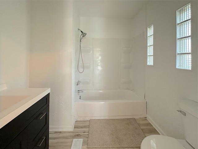 1006 Madison St, Three Rivers, MI 49093 - bathroom featuring vanity, wood finished floors, and bathtub / shower combination