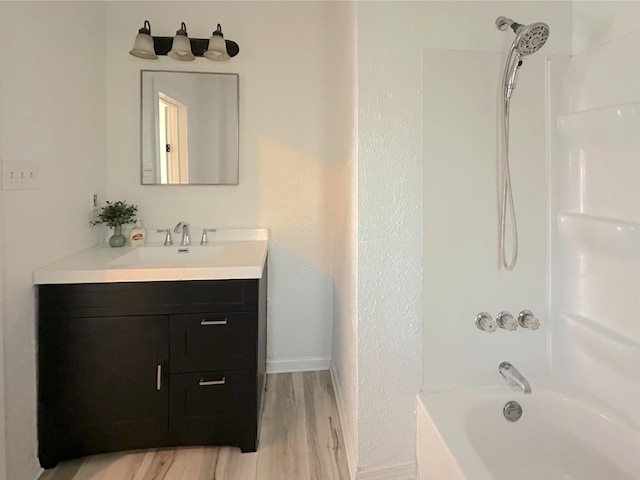 1006 Madison St, Three Rivers, MI 49093 - bathroom with vanity, bathtub / shower combination, and wood finished floors