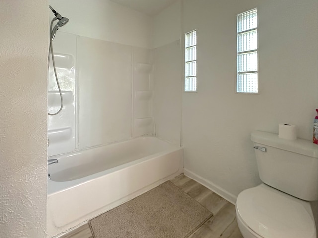 1006 Madison St, Three Rivers, MI 49093 - bathroom featuring wood finished floors and washtub / shower combination