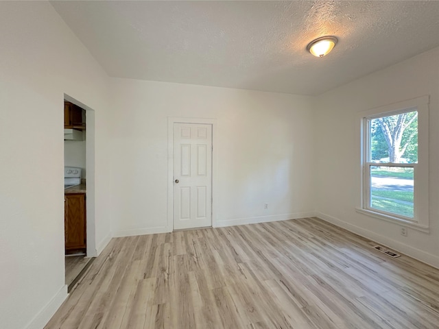 1006 Madison St, Three Rivers, MI 49093 - unfurnished room with light wood finished floors and a textured ceiling