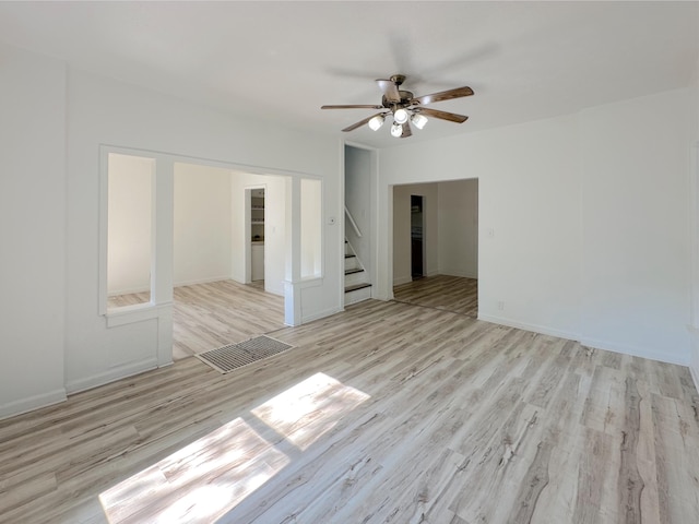 1006 Madison St, Three Rivers, MI 49093 - spare room with ceiling fan, stairs, and light wood-type flooring