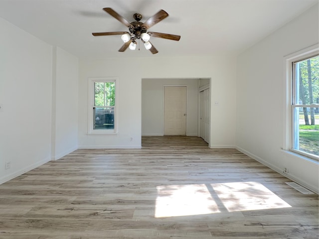 1006 Madison St, Three Rivers, MI 49093 - empty room with plenty of natural light, wood finished floors, and ceiling fan