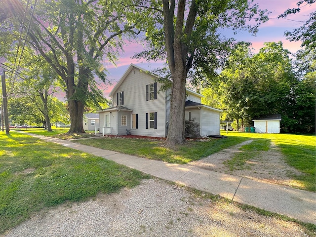 1006 Madison St, Three Rivers, MI 49093 - view of front of property with a shed, driveway, and a front lawn