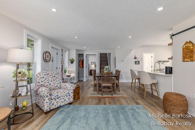 10840 Harvard Ave NE, Rockford, MI 49341 - living area featuring wood finished floors, recessed lighting, and a barn door