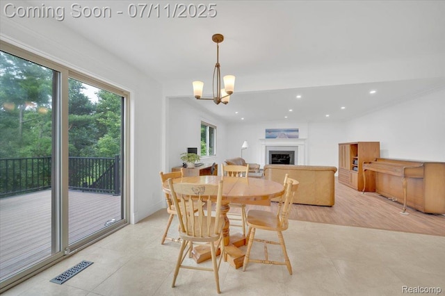 3417 Palm Aire Ct, Rochester Hills, MI 48309 - dining room with plenty of natural light, a fireplace, recessed lighting, a chandelier, and light tile patterned floors