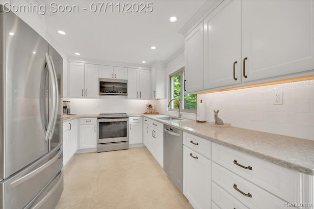 3417 Palm Aire Ct, Rochester Hills, MI 48309 - kitchen with appliances with stainless steel finishes, white cabinetry, recessed lighting, light stone counters, and decorative backsplash