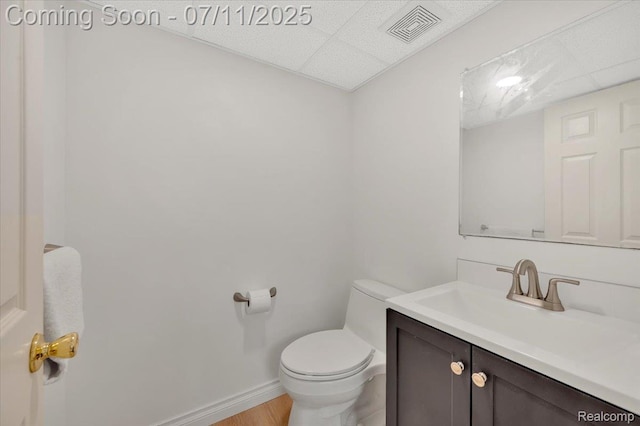 3417 Palm Aire Ct, Rochester Hills, MI 48309 - bathroom featuring vanity, a drop ceiling, and wood finished floors