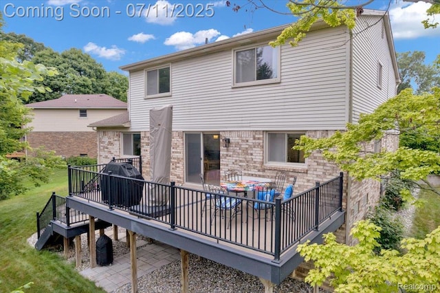 3417 Palm Aire Ct, Rochester Hills, MI 48309 - rear view of house featuring a deck, brick siding, and a yard