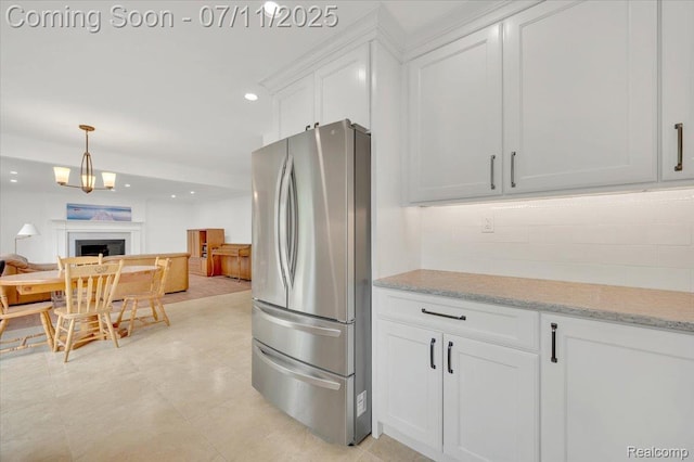 3417 Palm Aire Ct, Rochester Hills, MI 48309 - kitchen featuring freestanding refrigerator, white cabinetry, recessed lighting, light stone countertops, and open floor plan