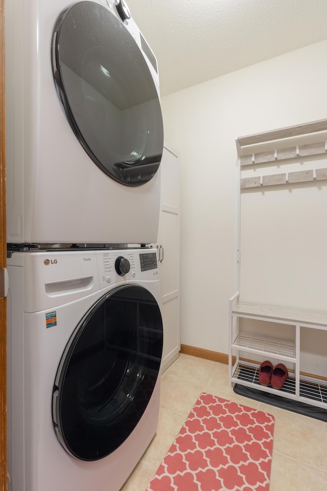 1428 Sherry Dr, Portage, MI 49024 - laundry room featuring stacked washer / drying machine and light tile patterned floors