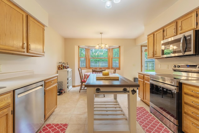 1428 Sherry Dr, Portage, MI 49024 - kitchen featuring stainless steel appliances, a chandelier, light countertops, light tile patterned floors, and hanging light fixtures