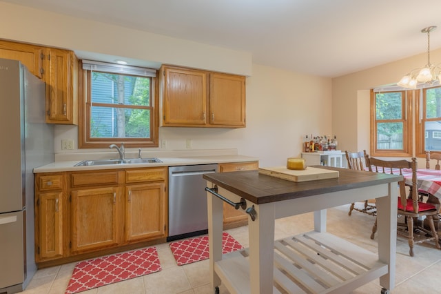 1428 Sherry Dr, Portage, MI 49024 - kitchen featuring stainless steel appliances, light countertops, a chandelier, decorative light fixtures, and light tile patterned flooring