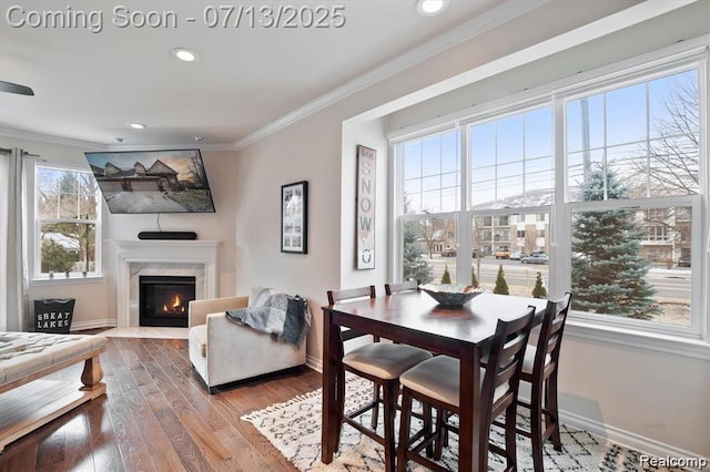42384 Gateway Dr, Plymouth, MI 48170 - dining space with wood finished floors, ornamental molding, a premium fireplace, and recessed lighting