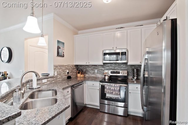 42384 Gateway Dr, Plymouth, MI 48170 - kitchen with appliances with stainless steel finishes, crown molding, white cabinetry, decorative backsplash, and pendant lighting