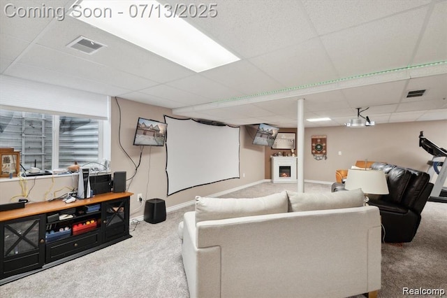 42384 Gateway Dr, Plymouth, MI 48170 - living area featuring carpet flooring, a paneled ceiling, and a lit fireplace
