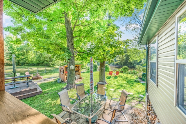 76 Meceola Ct, Hersey, MI 49639 - view of green lawn with a shed, a deck, and view of wooded area