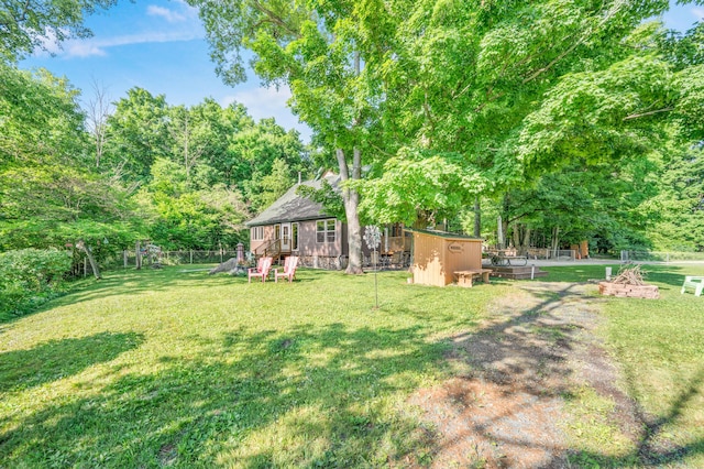 76 Meceola Ct, Hersey, MI 49639 - view of yard with a storage unit and a playground