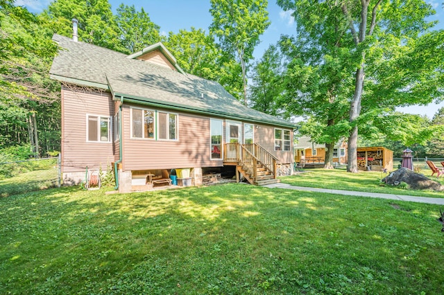 76 Meceola Ct, Hersey, MI 49639 - rear view of property featuring a shingled roof